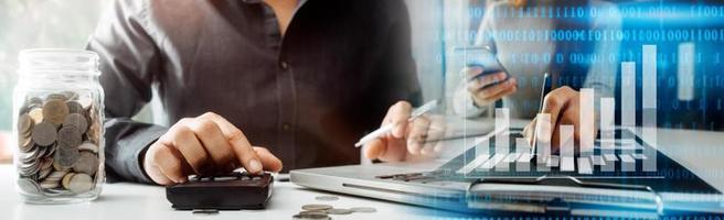 Business accounting concept, Business man using calculator with computer laptop, budget and loan paper in office. photo