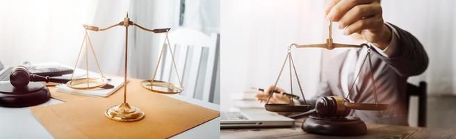 Justice and law concept.Male judge in a courtroom with the gavel, working with, computer and docking keyboard, eyeglasses, on table in morning light photo