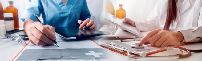 Medicine doctor hand working on a patients x-ray scans digital healthcare and connection with modern virtual screen interface icons, Medical technology and network concept. photo