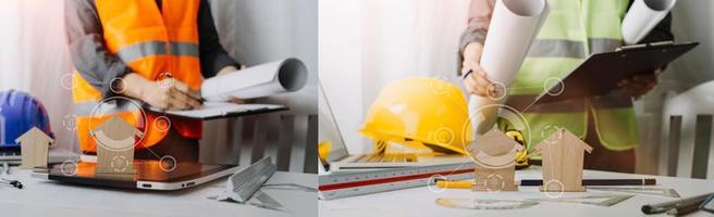 Two colleagues discussing data working and tablet, laptop with on on architectural project at construction site at desk in office photo