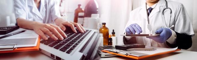 Medicine doctor hand working on a patients x-ray scans digital healthcare and connection with modern virtual screen interface icons, Medical technology and network concept. photo