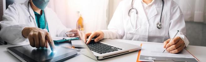 Medicine doctor hand working on a patients x-ray scans digital healthcare and connection with modern virtual screen interface icons, Medical technology and network concept. photo