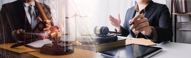 Business and lawyers discussing contract papers with brass scale on desk in office. Law, legal services, advice, justice and law concept picture with film grain effect photo