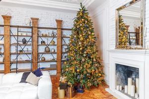 Classic christmas New Year decorated interior room New year tree with golden ornament decorations photo