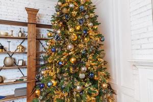 Classic christmas New Year decorated interior room New year tree with golden ornament decorations photo