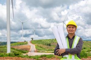 Engineer worker at wind turbine power station construction site photo