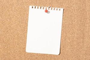 Blank notebook paper sheet pinned on cork board. Template Mock up photo