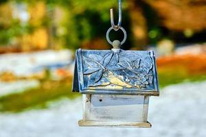 Rustic birdhouse hangs quietly as Spring awaits photo