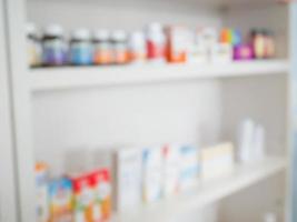 Close up of medicine bottles on shelves of drugs in the pharmacy photo