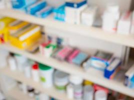 Close up of medicine bottles on shelves of drugs in the pharmacy photo