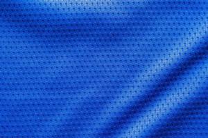 Blue color fabric sport clothing football jersey with air mesh texture background photo