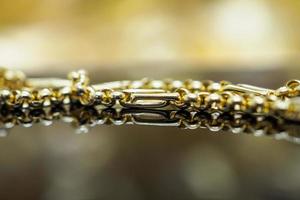 Luxury gold Jewelry bracelet with reflection on black background photo