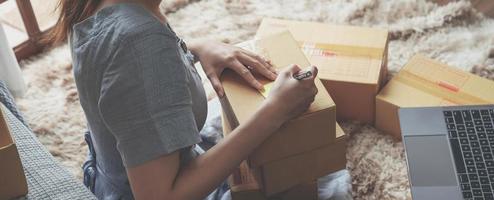 Small Entrepreneurs Start A Home Business By Arranging Goods With Brown Parcel Boxes, Small Home Business Startup Ideas. photo