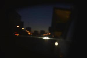 Multicolored reflections of lanterns on the evening road in the evening. Bluer and bokeh from the evening city. photo