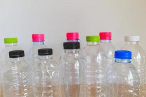 set of many plastic bottle on wood table, recycling concept photo