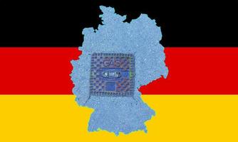 Outline map of Germany with the image of the national flag. Manhole cover of the gas pipeline system inside the map. Collage. Energy crisis. photo
