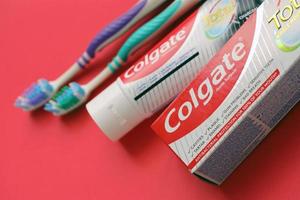 TERNOPIL, UKRAINE - JUNE 23, 2022 Colgate toothpaste and toothbrushes, a brand of oral hygiene products manufactured by American consumer-goods company Colgate-Palmolive photo