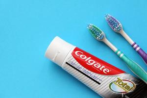 TERNOPIL, UKRAINE - JUNE 23, 2022 Colgate toothpaste and toothbrushes, a brand of oral hygiene products manufactured by American consumer-goods company Colgate-Palmolive photo