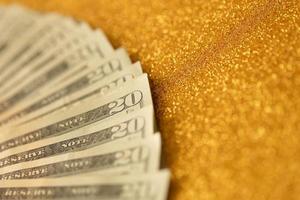 Big amount of old twenty dollar bills on golden background. Money earnings, payday or tax paying period photo