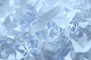 Shredded paper texture background, top view of many white paper strips. Pile of cut paper like box filler for shipping fragile items photo