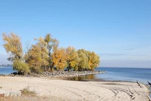 Beautiful autumn landscape with lake and multicoloral trees. Picturesque place with lake and tall trees photo
