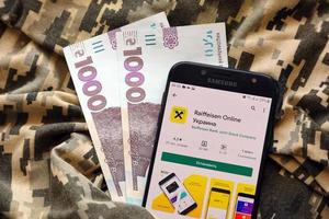 TERNOPIL, UKRAINE - APRIL 24, 2022 Raiffeisen banking app on smartphone screen. Raiffeisen is important commercial bank in Ukraine photo