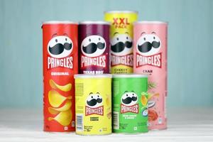 KHARKIV, UKRAINE - DECEMBER 16, 2021 Pringles product with new logo. Pringles is a brand of potato snack chips owned by the Kellogg Company photo