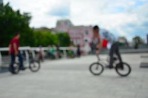 Defocused image of a lot of people with bmx bikes. Meeting of fans of extreme sports photo