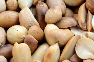 Peanut. A lot of small yellow nuts without peel. Background texture photo