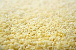 Texture of a lot of curly raw yellow pasta photo