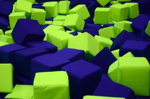 Many colorful soft blocks in a kids' ballpit at a playground photo