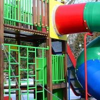 Fragment of a playground made of plastic and wood, painted in different colors photo