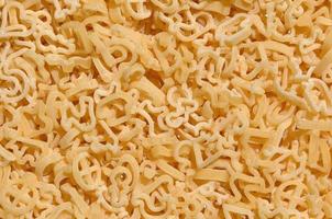 Texture of a lot of curly raw yellow pasta photo