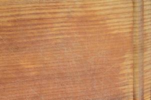 Detailed texture of the wooden cutting board with a lot of scars from the ax and knife photo