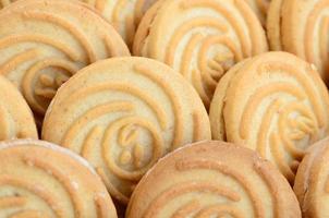 Close-up of a large number of round cookies with coconut filling photo