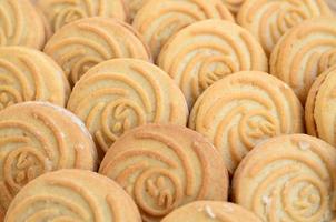 Close-up of a large number of round cookies with coconut filling photo