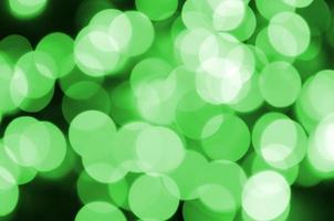 Green abstract Christmas blurred luminous background. Defocused artistic bokeh lights image photo