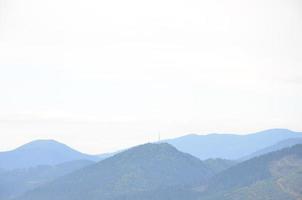 Fragment of the mountainous terrain in the Carpathians, Ukraine. The forest is forgiven by the reliefs of the Carpathian Mountains photo