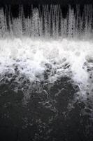 A picture of the flowing water. The dam is designed to regulate the water level in rivers within the city and to provide technical water to industrial objects photo