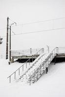 Metal steps leading to the railway station. The steps are covered with snow after a heavy snowfall photo