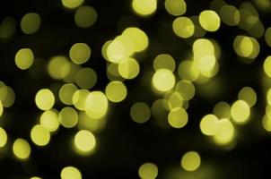 Bokeh effect golden yellow defocused light background. Christmas Lights Concept photo