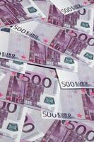 Close up background photo Amount of Five hundred notes of European Union Currency. Many pink 500 euro banknotes are adjacent. Symbolic texture photo for wealth
