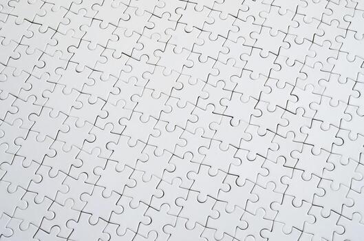Close up texture of a white jigsaw puzzle in assembled condition. Top view. Many components of a large whole mosaic are united photo