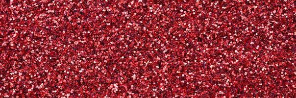 A huge amount of red decorative sequins. Background texture with shiny, small elements that reflect light in a random order. Glitter texture photo