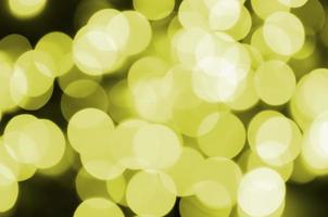 Bokeh effect golden yellow defocused light background. Christmas Lights Concept photo