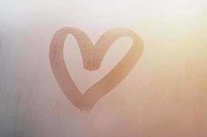 Autumn rain, the inscription on the sweaty glass - love and heart. Soft and beautiful background image with copy space photo