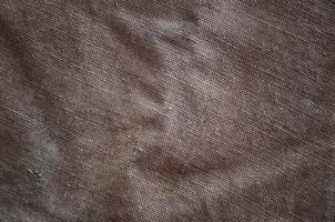 The texture of a very old brown sack cloth. Retro texture with canvas material. Background image with copy space photo