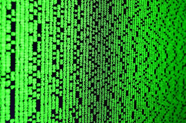 Macro of password selection on the monitor of the office computer. The concept of hacking the protection of a personal data keeper. The stream of supposed digital passwords of four and five digits
