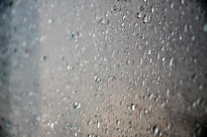 Background image of rain drops on a glass window. Macro photo with shallow depth of field