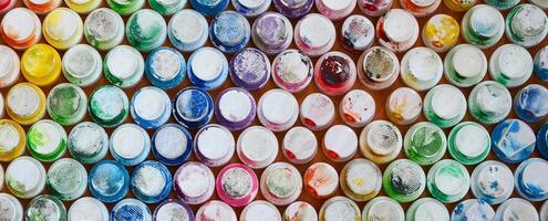 A pattern from a many nozzles from a paint sprayer for drawing graffiti, smeared into different colors. The plastic caps are arranged in many rows forming the color of the rainbow photo